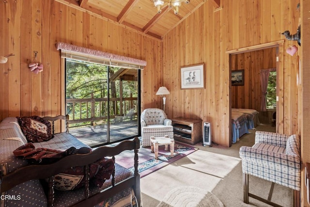 interior space featuring beamed ceiling, carpet flooring, and wood walls