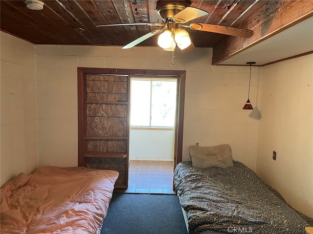 bedroom with wood ceiling, carpet flooring, and ceiling fan