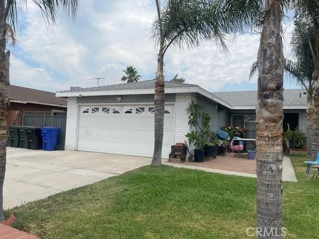 view of side of property featuring a yard and a garage