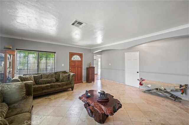 tiled living room featuring crown molding