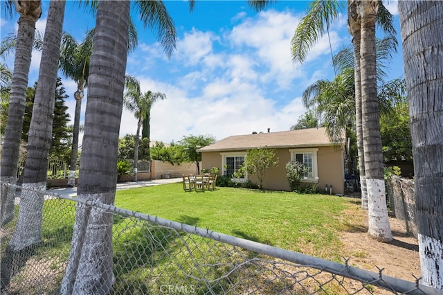 rear view of property featuring a yard