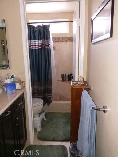 bathroom featuring walk in shower, vanity, toilet, and tile patterned floors