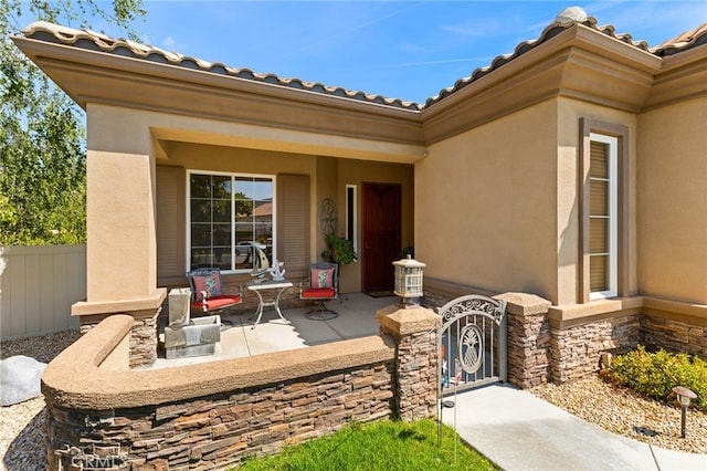 property entrance featuring a patio