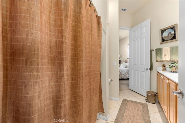 bathroom with tile patterned floors and vanity