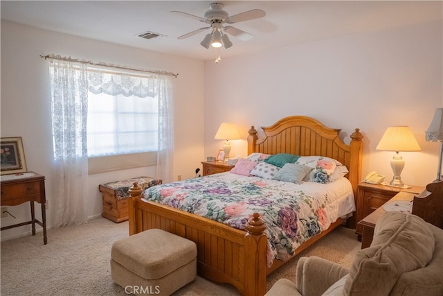 bedroom with ceiling fan and light colored carpet