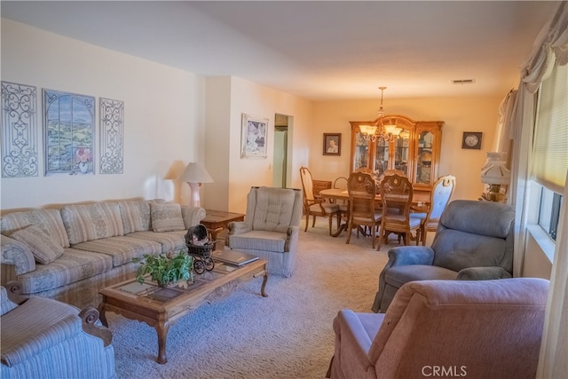 living room with carpet flooring and a notable chandelier