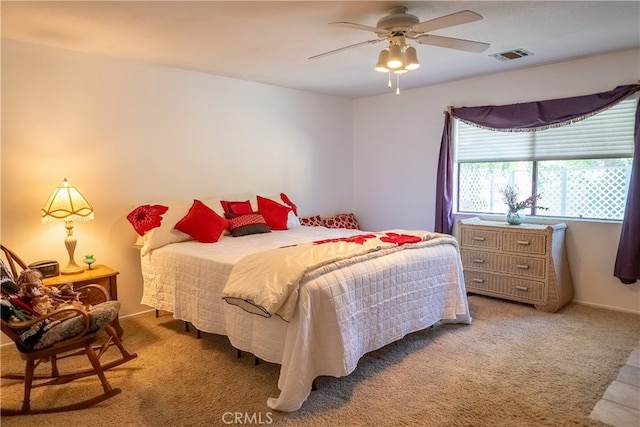 bedroom with ceiling fan and light carpet