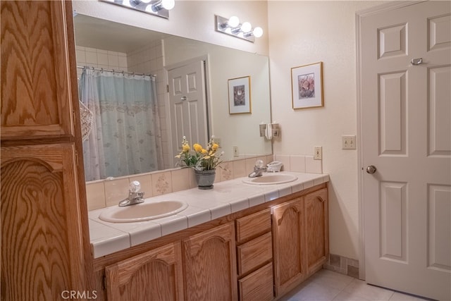 bathroom with tile patterned floors and vanity