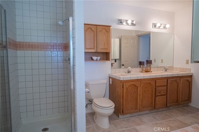 bathroom with an enclosed shower, vanity, and toilet