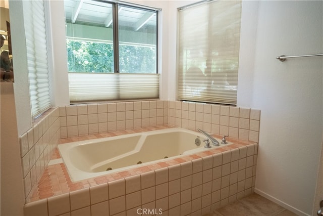 bathroom featuring tile patterned flooring and tiled bath