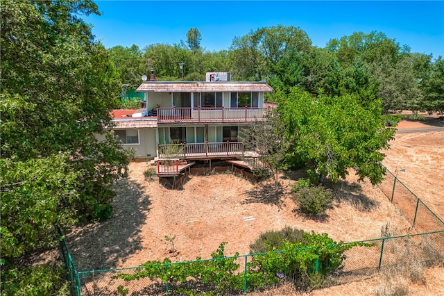 rear view of property featuring a balcony