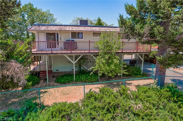 rear view of property featuring a wooden deck