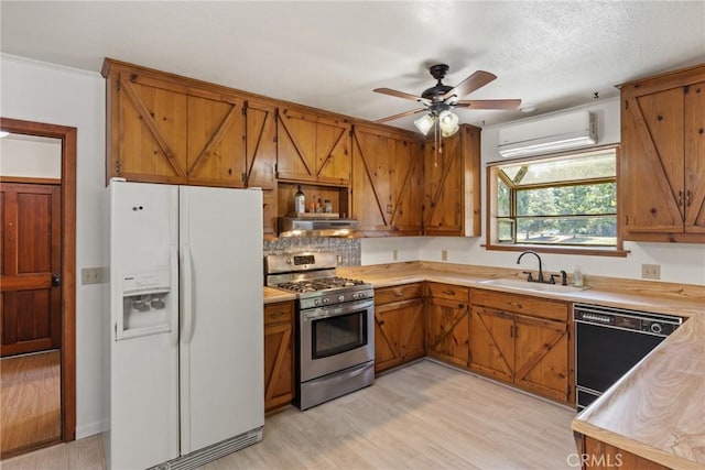 kitchen featuring brown cabinets, white fridge with ice dispenser, a wall mounted air conditioner, gas range, and dishwasher