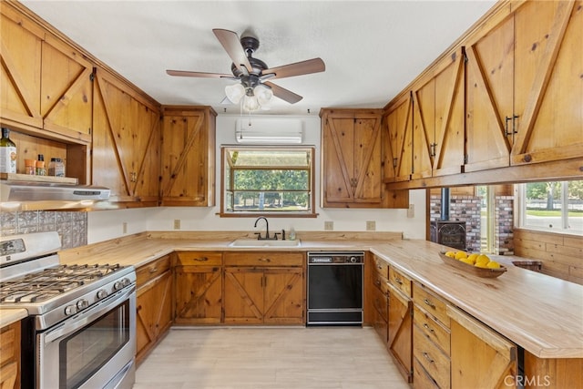 kitchen with gas stove, black dishwasher, sink, exhaust hood, and ceiling fan