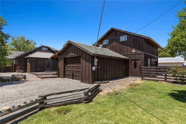 view of front facade featuring board and batten siding, driveway, fence, a garage, and a front lawn