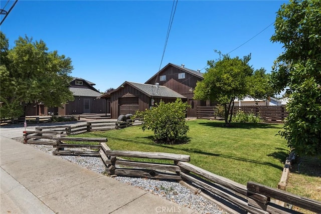 view of community with a lawn and fence