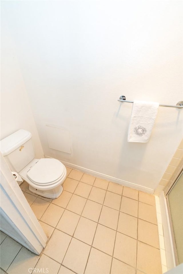 bathroom with tile patterned flooring and toilet