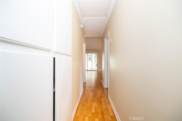 hallway with light hardwood / wood-style floors