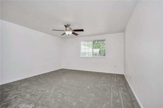 spare room featuring carpet and ceiling fan