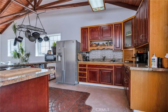 kitchen featuring stainless steel fridge, tasteful backsplash, sink, lofted ceiling with beams, and wooden ceiling