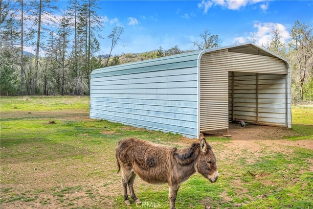 view of outbuilding with a lawn