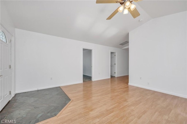 empty room with lofted ceiling, ceiling fan, and light wood-type flooring