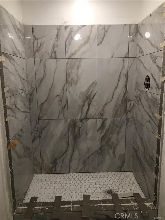 bathroom with tiled shower