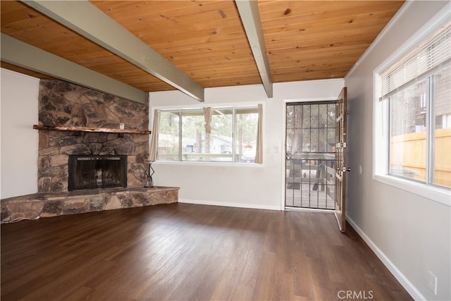 unfurnished living room featuring a stone fireplace, hardwood / wood-style flooring, wood ceiling, and beamed ceiling