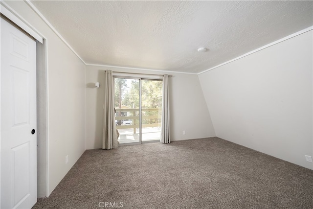 unfurnished room featuring a textured ceiling, lofted ceiling, and carpet flooring