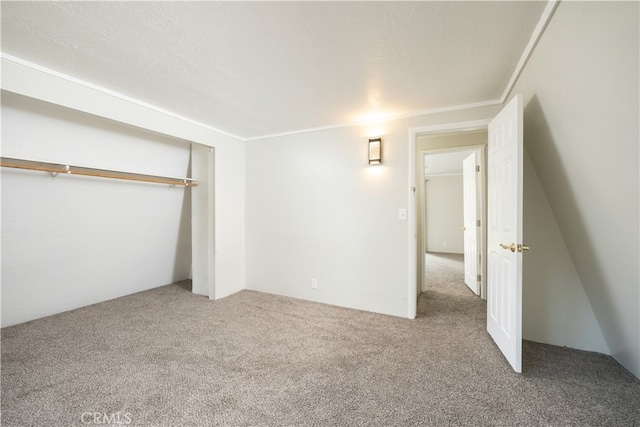 unfurnished bedroom with a closet, carpet floors, and a textured ceiling