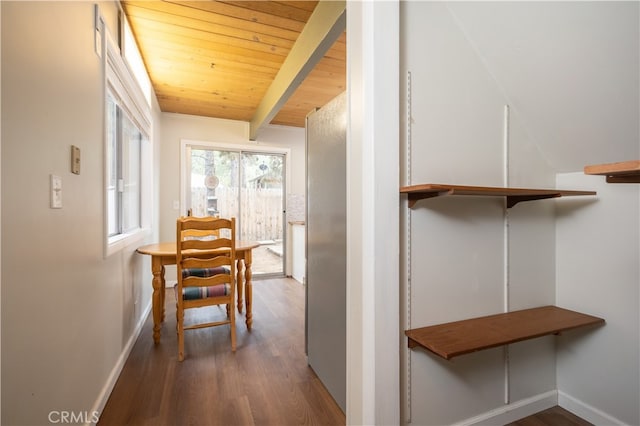 hallway with wood ceiling, beamed ceiling, and hardwood / wood-style flooring