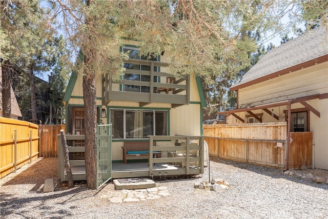 back of property featuring a wooden deck