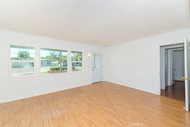 unfurnished room featuring a wealth of natural light and light hardwood / wood-style flooring