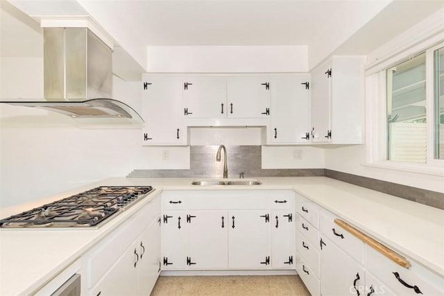 kitchen with sink, white cabinets, exhaust hood, and stainless steel gas stovetop