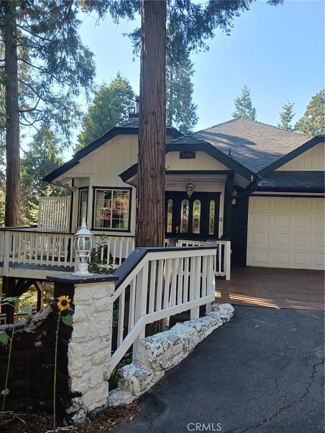 24048 Altdorf Dr, Crestline, CA 92325 - view of front of house featuring an attached garage, a shingled roof, and driveway