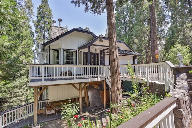 rear view of property featuring a deck