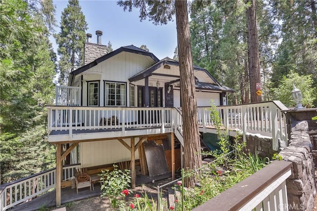 24048 Altdorf Dr, Crestline, CA 92325 - rear view of property with a wooden deck and a chimney