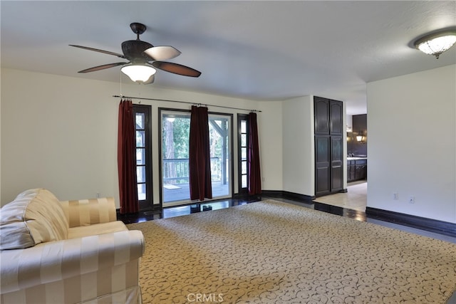 unfurnished living room with ceiling fan