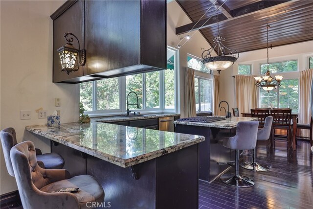 kitchen featuring wood ceiling, dark hardwood / wood-style floors, light stone countertops, and a kitchen bar