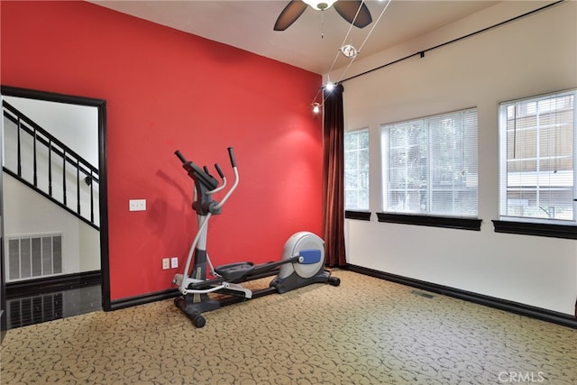 exercise area with carpet floors and ceiling fan