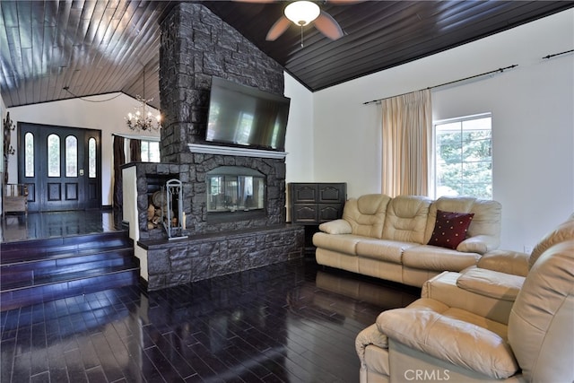 living room featuring hardwood / wood-style floors, a stone fireplace, ceiling fan with notable chandelier, and high vaulted ceiling