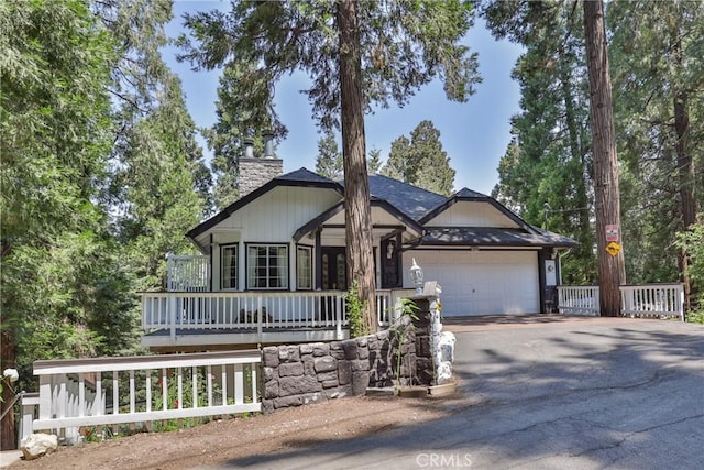 24048 Altdorf Dr, Crestline, CA 92325 - view of front of property featuring asphalt driveway, an attached garage, and a chimney