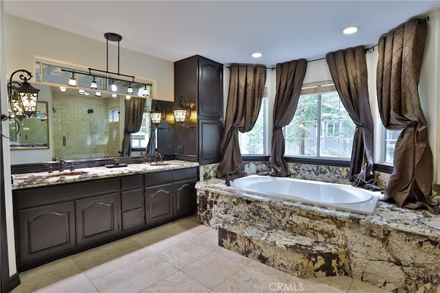 bathroom featuring vanity, shower with separate bathtub, and tile patterned floors