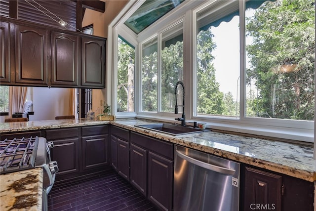 kitchen featuring vaulted ceiling with beams, dark brown cabinets, stainless steel appliances, sink, and light stone countertops