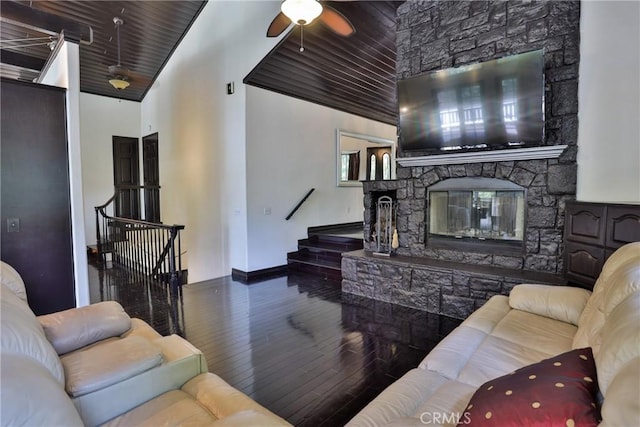 24048 Altdorf Dr, Crestline, CA 92325 - living area featuring wood finished floors, stairway, a fireplace, a ceiling fan, and high vaulted ceiling
