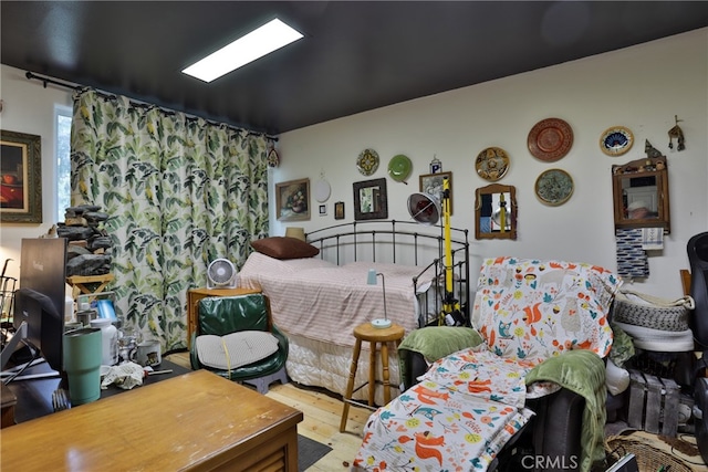 bedroom with hardwood / wood-style floors