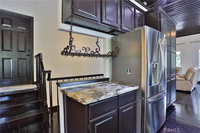 24048 Altdorf Dr, Crestline, CA 92325 - kitchen with stainless steel fridge, light stone counters, dark wood-style floors, and dark brown cabinets