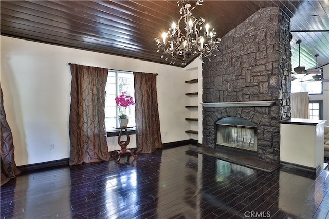 unfurnished living room featuring dark wood-type flooring, a notable chandelier, a stone fireplace, and wooden ceiling