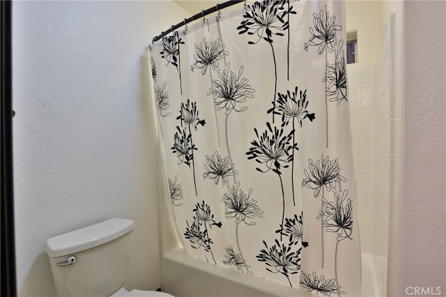 bathroom featuring toilet and shower / bathtub combination with curtain