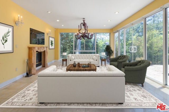 living room with a chandelier and a fireplace